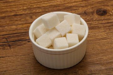 Refined white sugar cubs in the bowl