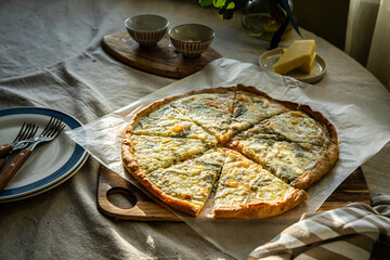 Homemade pizza with gorgonzola, mozzarella and almond flakes on wholegrain dough.