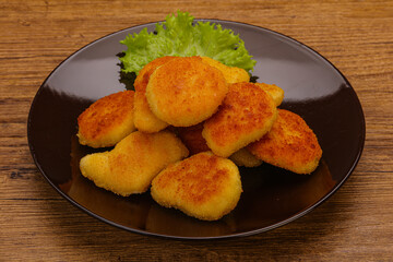 Fried chicken nuggets served salad leaves