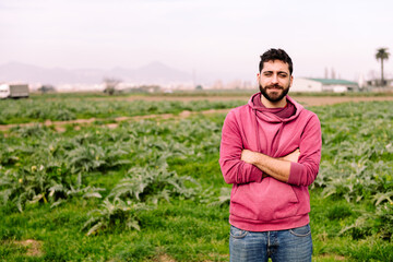 Fototapeta premium young entrepreneur farmer in front of a farm field