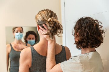 Fototapeta premium Physiotherapist and patient in Global Postural correction session, with pandemic protection mask.