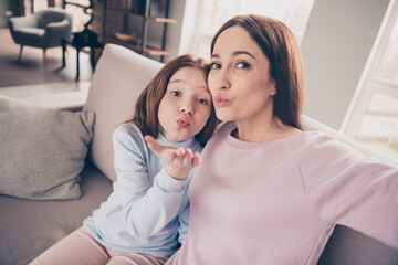 Photo of adorable positive lady cute pupil take selfie arm palm sen air kiss to camera you have fun home indoors © deagreez