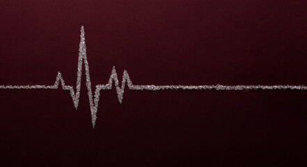 Heart rate graph using white sugar on red background