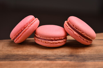 Colorful macaroons. Sweet macarons on retro dark background