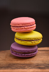 Colorful macaroons. Sweet macarons on retro dark background