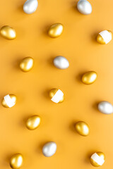 Happy Easter card with golden and silver eggs, top view