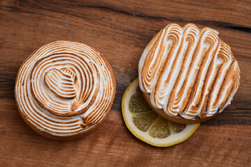 Tasty lemon meringue pie on wooden table, closeup