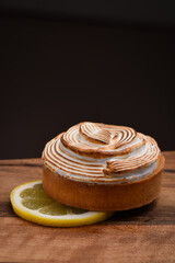 Tasty lemon meringue pie on wooden table, closeup
