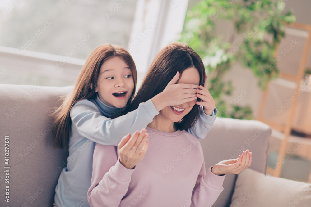 Wall mural photo of optimistic brunette red hairdo mom daughter hug play close eyes on sofa wear sweater at hom