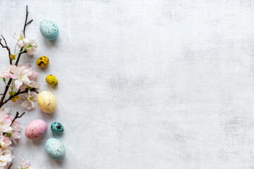 Easter eggs and spring flowers, top view
