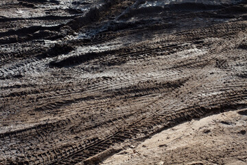 dirt on the road with wheels from cars. Lots of dirt dirty roads autumn