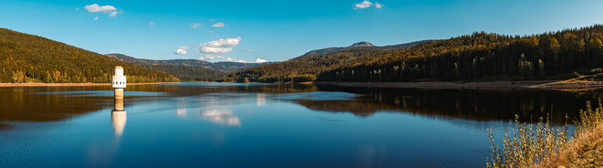 Fototapeta na wymiar High resolution stitched panorama of a beautiful autumn or indian summer view with reflections at the famous drinking water reservoir Frauenau, Bavarian forest, Bavaria, Germany
