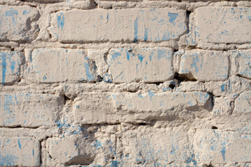 brick wall of white milky color with blue spots