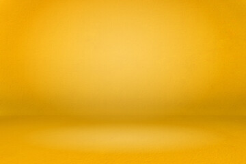 abstract gold gradient spotlight room texture background. Yellow background with little grunge. Studio backdrop wallpaper light room wall golden and empty space.