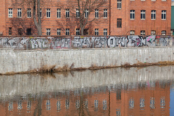 Reflective brick building in the river. Wroclaw, Poland.