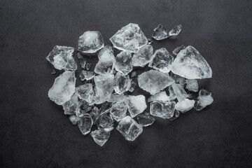 A pile of crushed ice cubes on a black background gourmet catering background