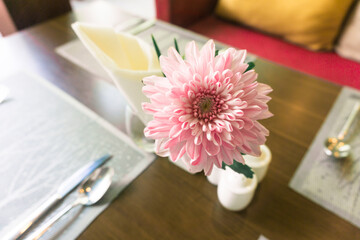 Dining table set up with fork and spoon and flower in luxury restaurant