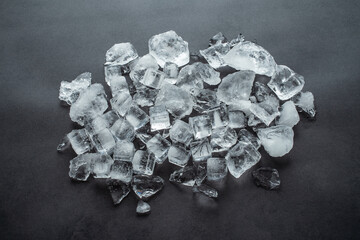 A pile of crushed ice cubes on a black background gourmet catering background