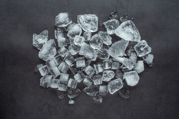 A pile of crushed ice cubes on a black background gourmet catering background