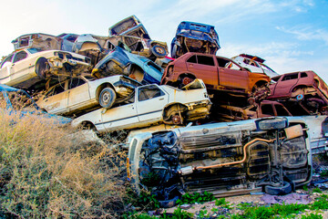 Pile of colorful discarded cars on junkyard - obrazy, fototapety, plakaty