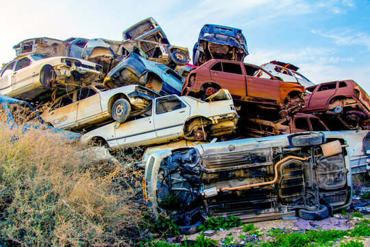 Pile of colorful discarded cars on junkyard
