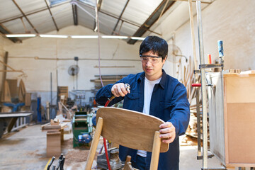 Craftsman apprentice repairing table - obrazy, fototapety, plakaty