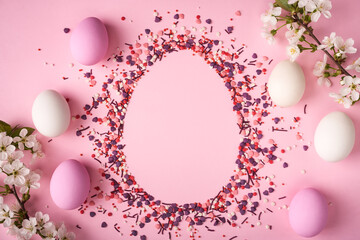 Easter eggs scattered on pink background with copy space above © paffy