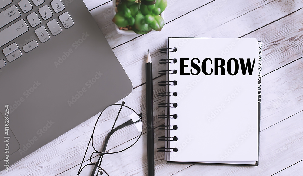 Poster escrow text on the notebook with office background