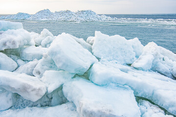 Ice heaps in the foreground and background. Frozen sea