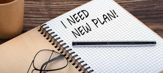 I NEED NEW PLAN words written on office notebook. Concept in business.