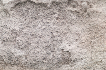 Natural stone background texture.  Natural lighting, textured surface for use as a textured layer or overlay.