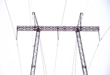 A high-voltage power line against a cloudy sky.