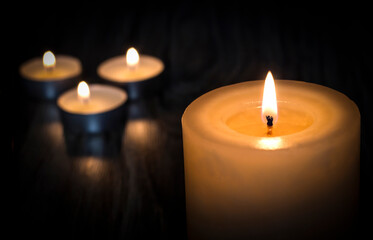 Tragedy. Death. Candles on a wooden background.