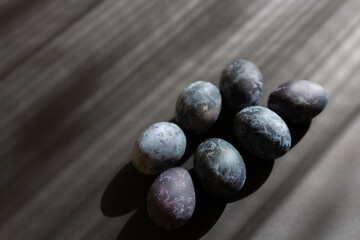 Painted Blue marble easter eggs on gray background with copy space. Dark creative easter 2021 concept.