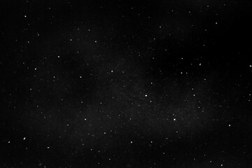 Flying snow on black background. Snow overlay texture. High quality photo