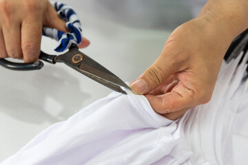Detail of employee working in Chinese clothing factory