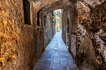 Fototapeta premium Old historic buildings along a narrow street. Venice, Italy