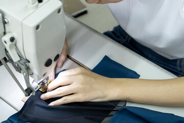 Detail of employee working in Chinese clothing factory