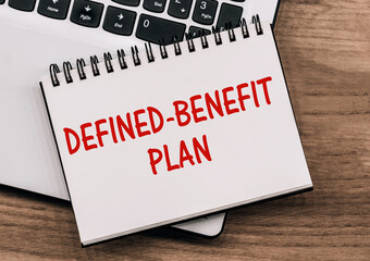 DEFINED-BENEFIT PLAN - inscription on notepad on laptop keyboard.