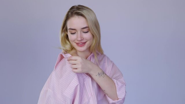 Delighted blond female with bare shoulder