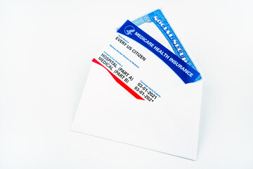 Every us citizen text on blank medicare health card in envelope isolated on white with social security card.
