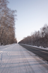 Snowy winter road in the forest