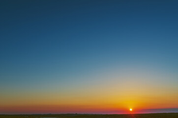 Stunning sunset with orange and blue clouds in dramatic sky