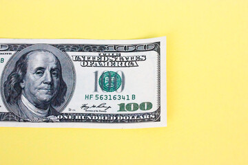 Hundred dollar bill close-up on yellow background. Space for text. Economy, business and financial profit concept. High quality photo