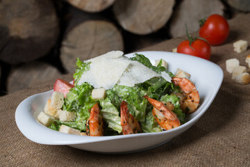 Caesar with fried shrimps in restaurant