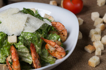 Caesar with fried shrimps in restaurant