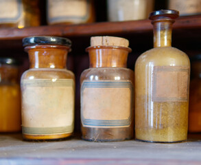 A bottle of poison on a background of old medical, chemistry and pharmacy glass. Chemistry and...