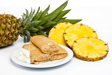 Rolled stuffed pancake on white plate 