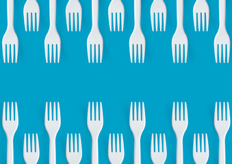 Pattern of white forks on blue background. Creative and modern concept with copy space.