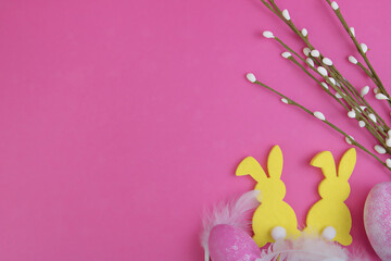 Easter background. Silhouette of rabbits, Easter eggs and pussy willow on a pink background. Copy space.